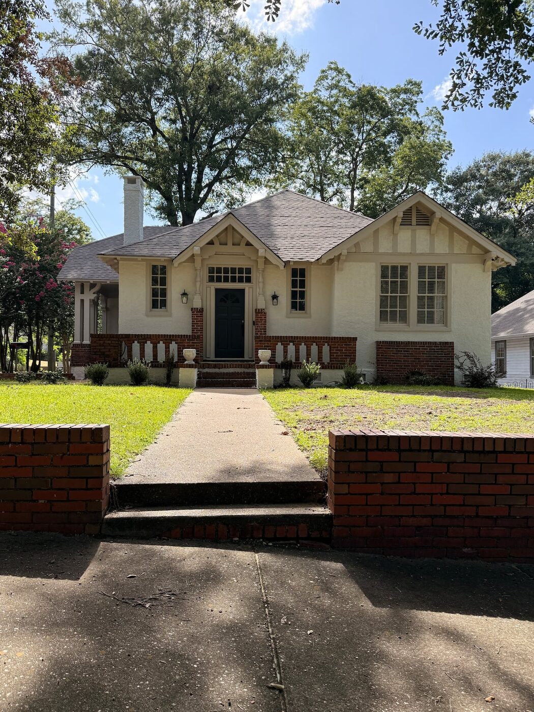 The Lawrence House bungalow exterior and brick walkway in the Garden District